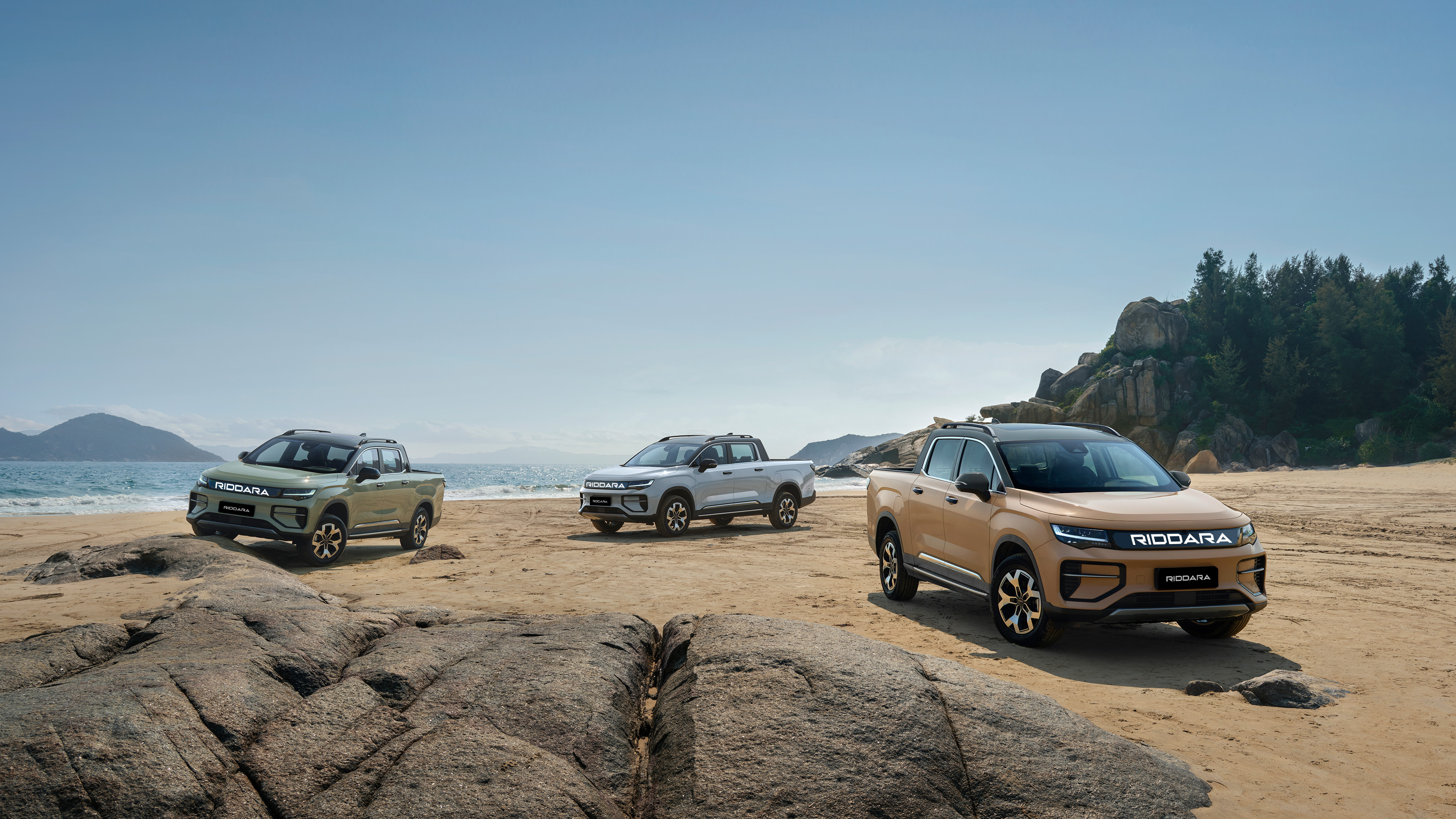 Three Riddara RD6 electric utes on a beach in official New Zealand model imagery